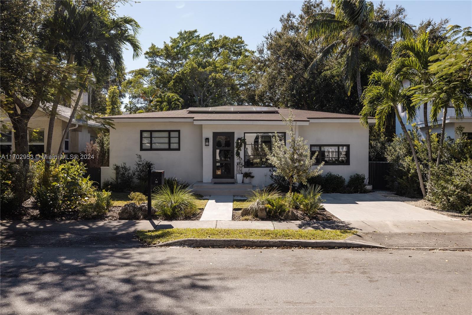 56 Northeast 46th Street Miami, FL 33137 - Photo 27 of 28 a front view of a house with garden and trees