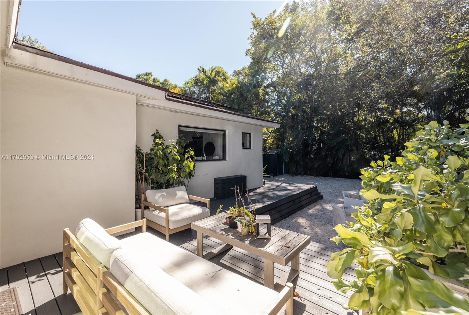 56 Northeast 46th Street Miami, FL 33137 - Photo 28 of 28 a view of a patio with couches table and chairs with potted plants