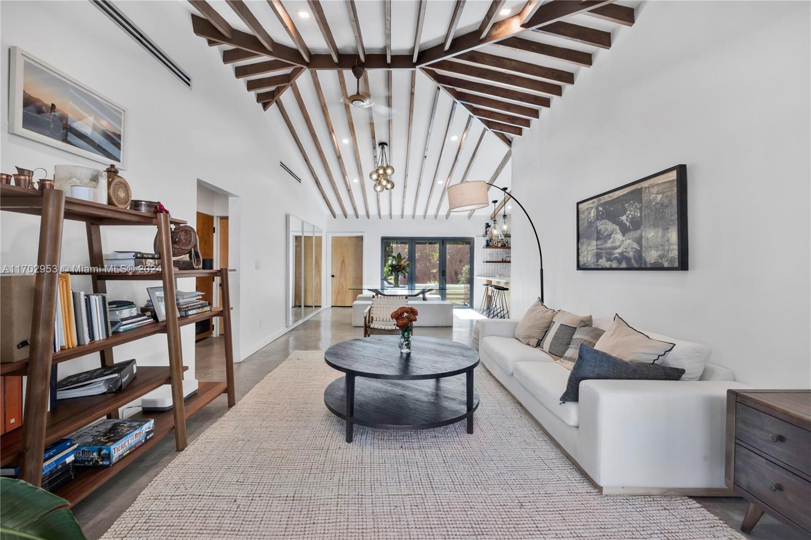 56 Northeast 46th Street Miami, FL 33137 - Photo 3 of 28 a living room with furniture and a chandelier