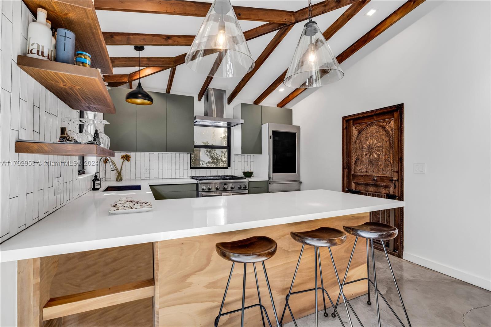 56 Northeast 46th Street Miami, FL 33137 - Photo 6 of 28 a view of a kitchen with a table and chairs