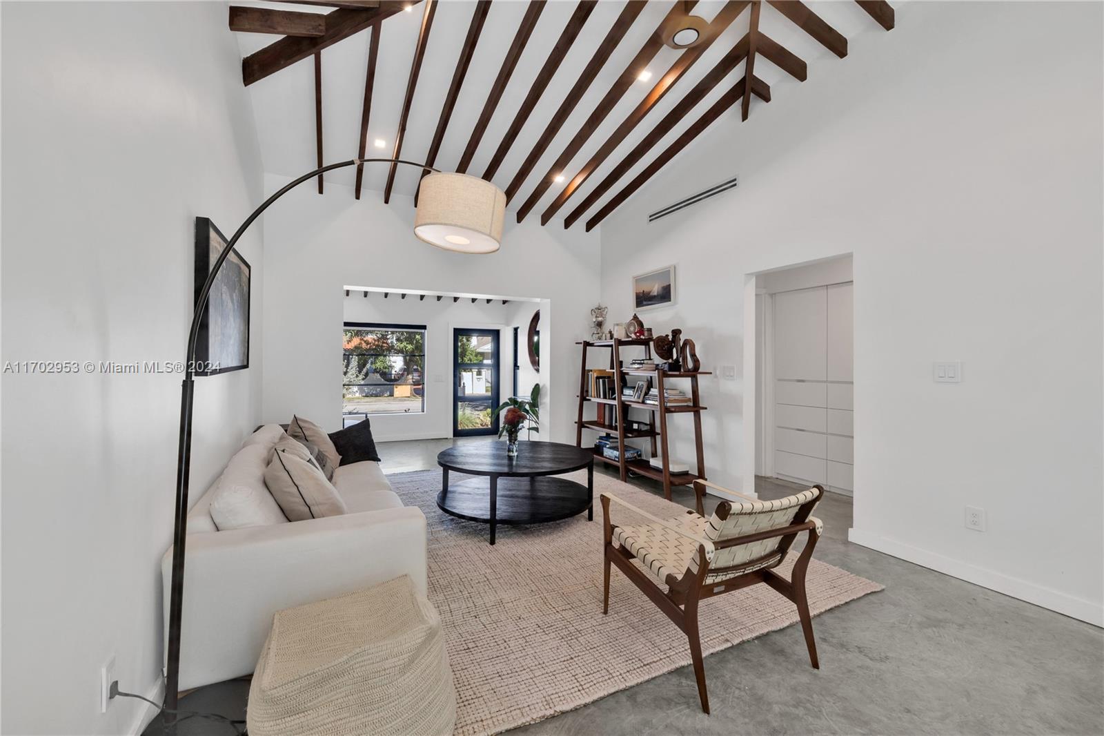 56 Northeast 46th Street Miami, FL 33137 - Photo 9 of 28 a living room with furniture and a chandelier