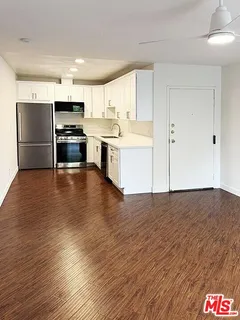 a kitchen with stainless steel appliances a refrigerator and a stove top oven