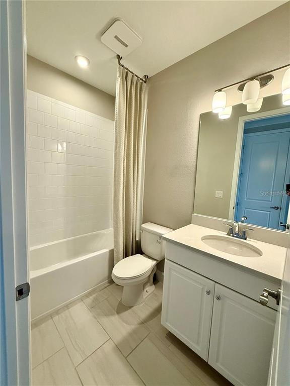 5967 Maidenstone Way Palmetto, FL 34221 - Photo 19 of 28 a bathroom with a double vanity sink toilet mirror and bathtub