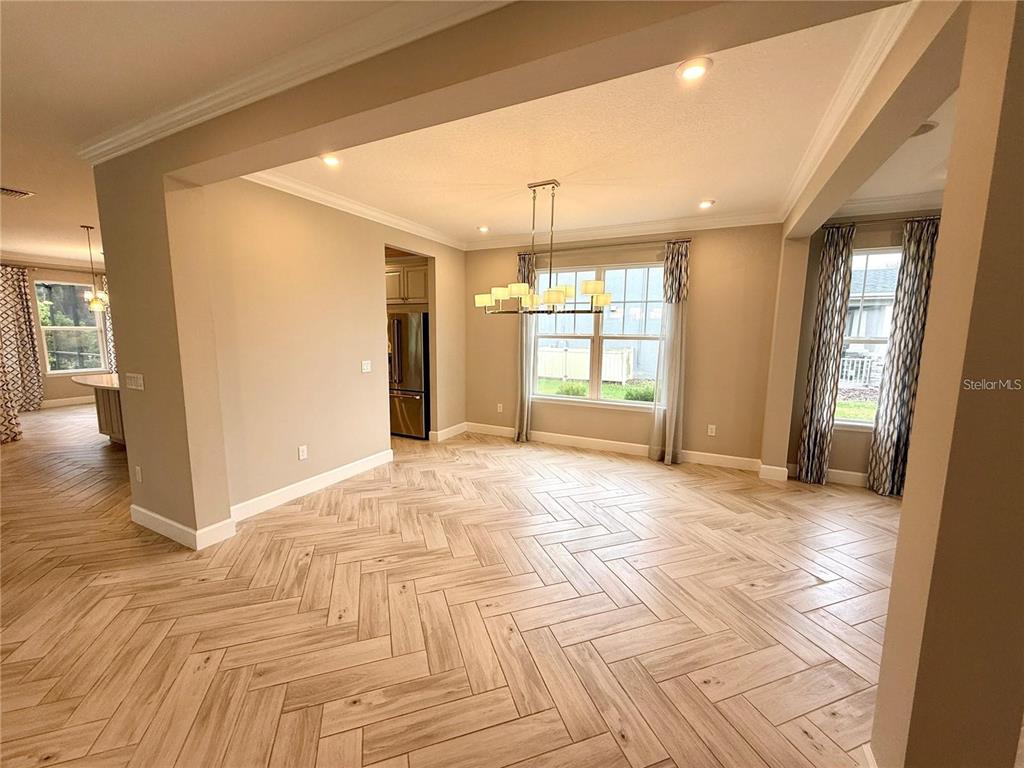 5967 Maidenstone Way Palmetto, FL 34221 - Photo 6 of 28 a view of an empty room with window and wooden floor