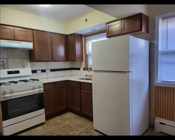a kitchen with stainless steel appliances granite countertop a refrigerator a stove a sink and a microwave