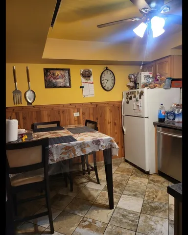 a kitchen with a refrigerator and a stove
