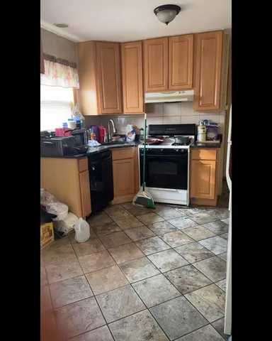 a kitchen with a stove a sink and a refrigerator