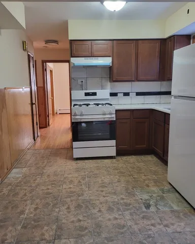 a kitchen with stainless steel appliances a stove a refrigerator and a sink