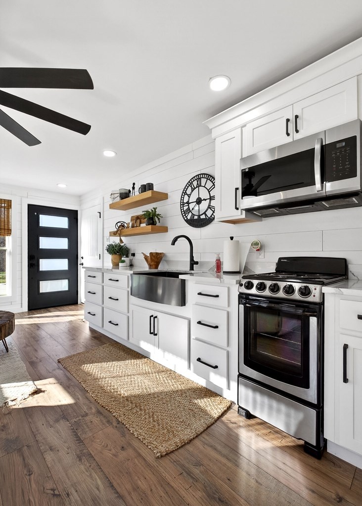 6081 Buck Mountain Road Cookeville, TN 38506 - Photo 40 of 71 a kitchen with stainless steel appliances a stove and a microwave