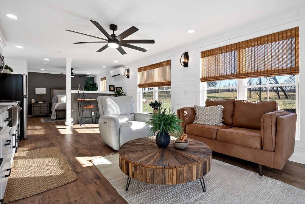 6081 Buck Mountain Road Cookeville, TN 38506 - Photo 42 of 71 a living room with furniture a ceiling fan and a window