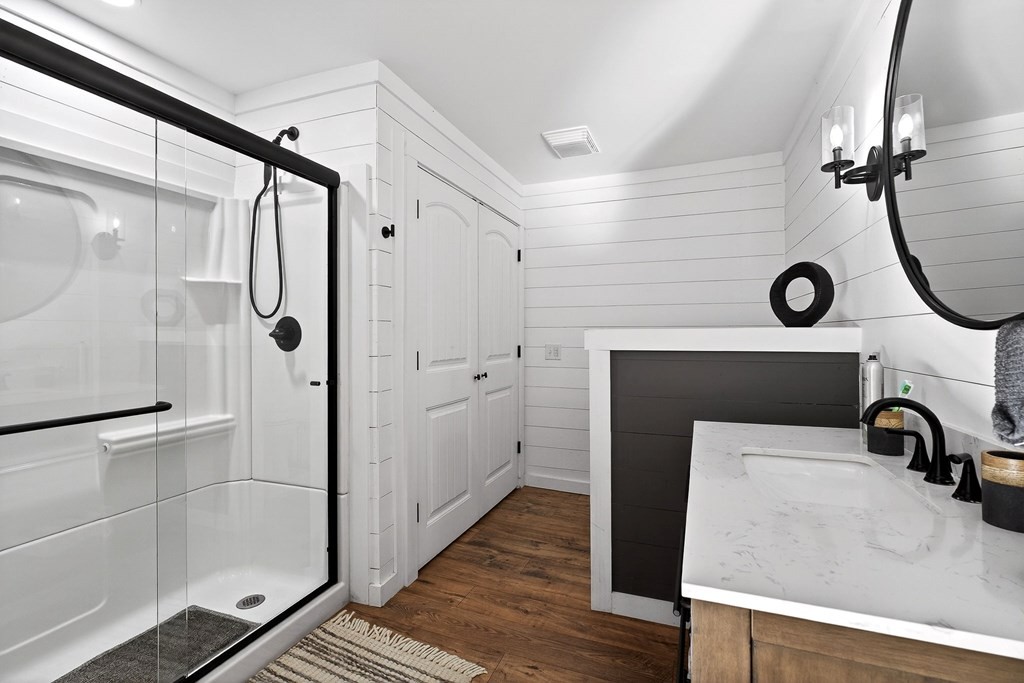 6081 Buck Mountain Road Cookeville, TN 38506 - Photo 60 of 71 a bathroom with a sink a glass door shower and a mirror