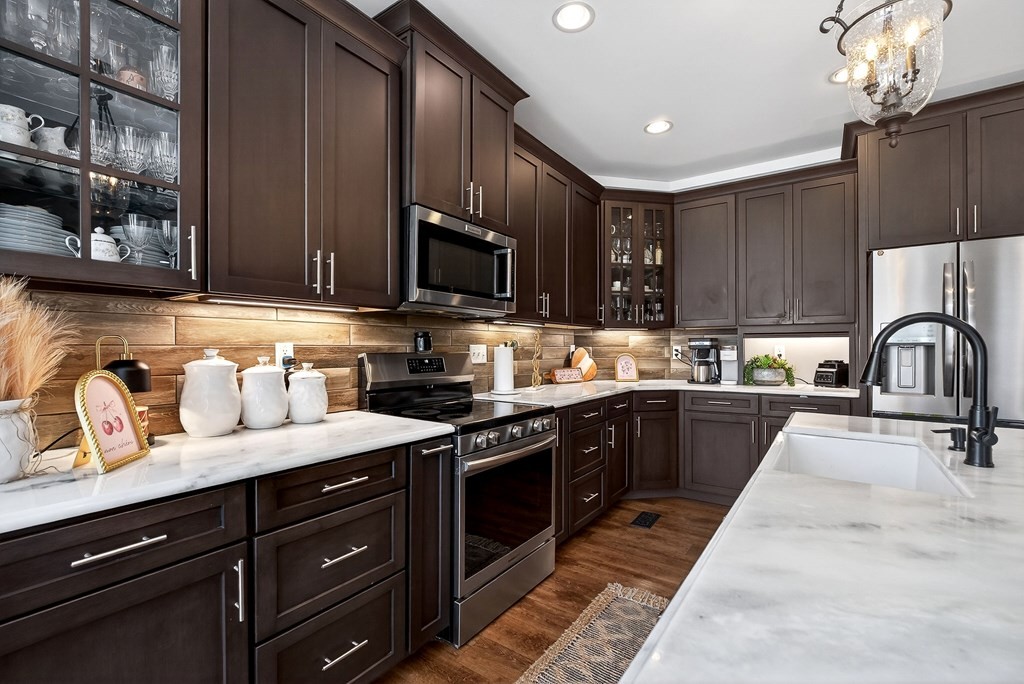 6081 Buck Mountain Road Cookeville, TN 38506 - Photo 9 of 71 a kitchen with granite countertop a sink stainless steel appliances and cabinets