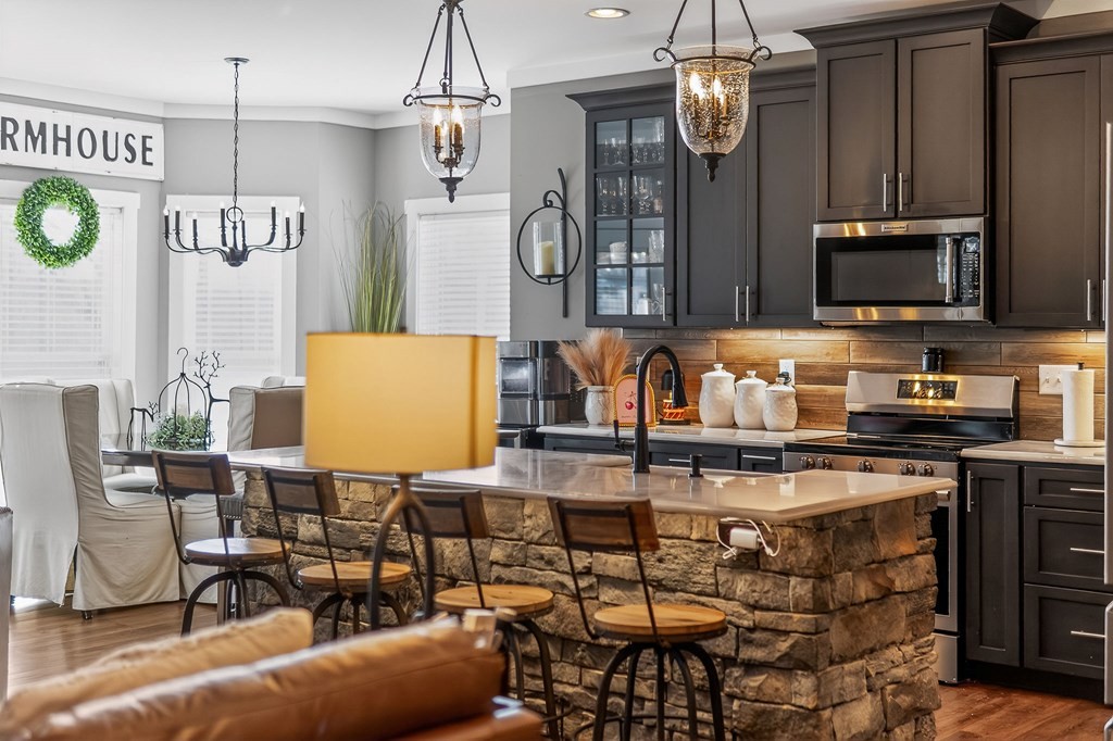 6081 Buck Mountain Road Cookeville, TN 38506 - Photo 10 of 71 a kitchen with stainless steel appliances granite countertop a sink a stove top oven a chimney and a dining table