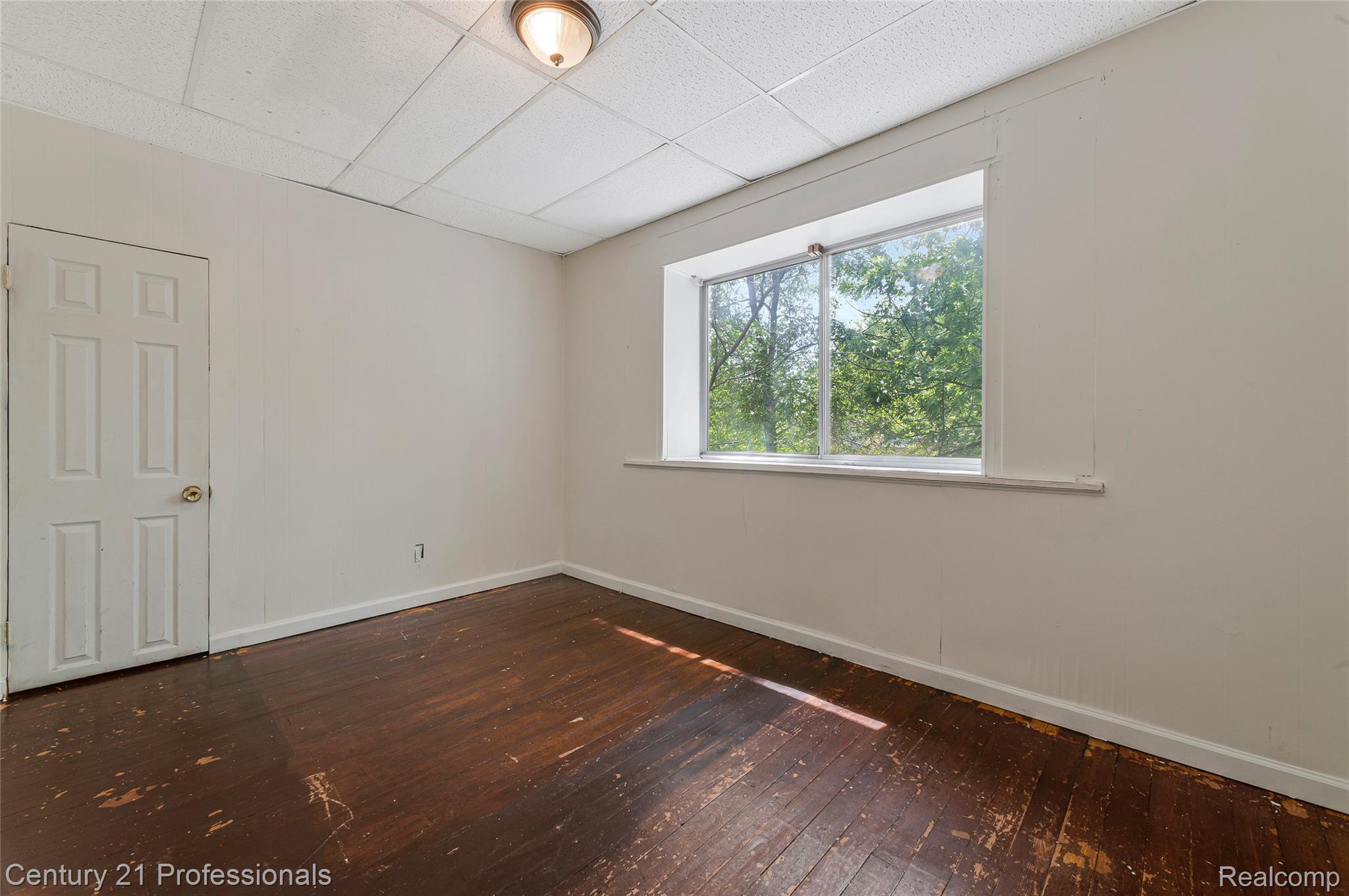 238 Richter Street River Rouge, MI 48218 - Photo 16 of 33 Room featuring wood-finish flooring, white walls, and a multi-pane window
