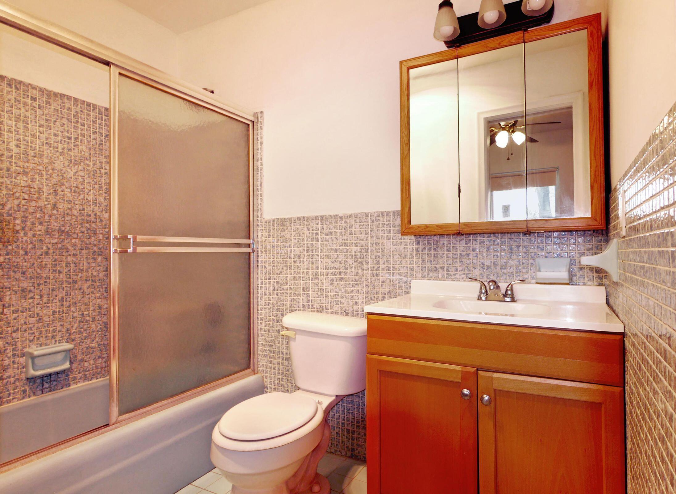 2031 Southeast 5th Street, Unit 8 Deerfield Beach, FL 33441 - Photo 9 of 13 a bathroom with a sink a toilet and shower