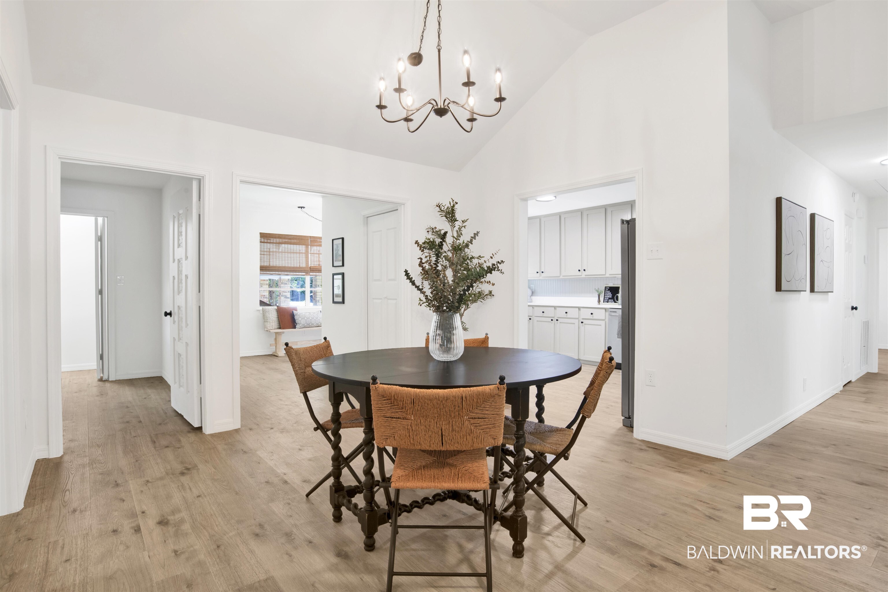 317 Lee Street Chickasaw, AL 36611 - Photo 8 of 40 Dining space featuring a chandelier, light wood-style flooring, and high vaulted ceiling