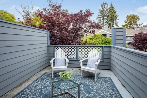 a bench sitting in backside of a house