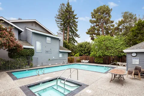 a view of a house with a backyard and a patio