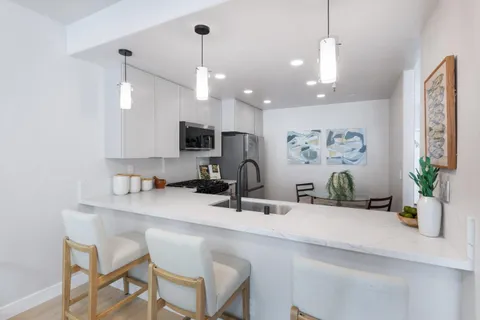 a kitchen with counter space a sink and appliances