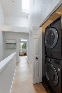 a view of a hallway with washer and dryer