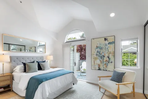 a spacious bedroom with a bed and a couch