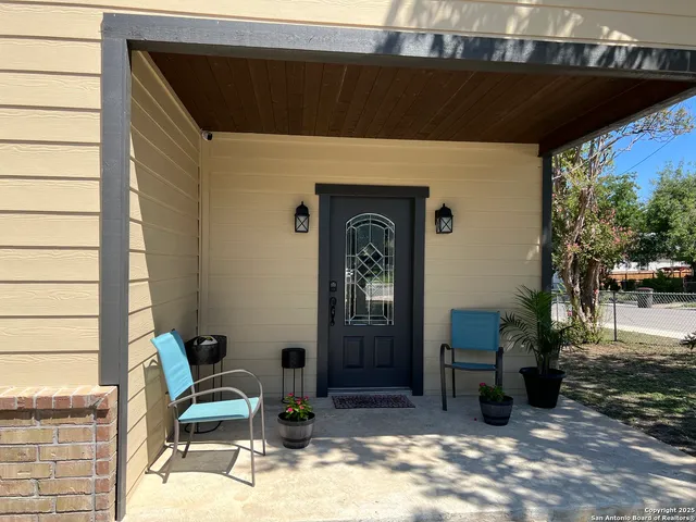 a front view of a house with outdoor seating
