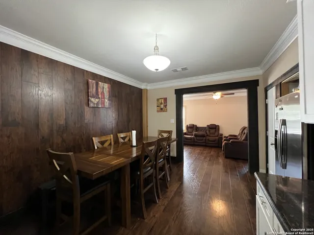 a view of a livingroom with furniture wooden floor and a large window