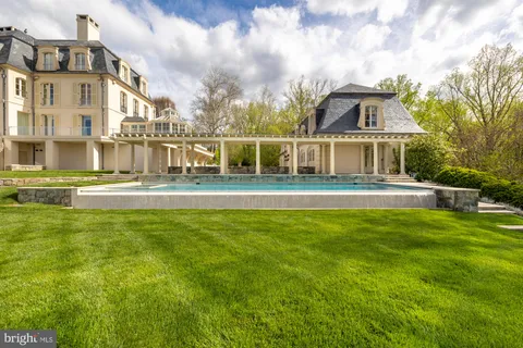 a living room with furniture chandelier and a fireplace