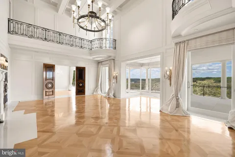 a spacious bedroom with a large bed and a large window