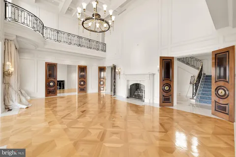 a living room with furniture a chandelier and a dining table