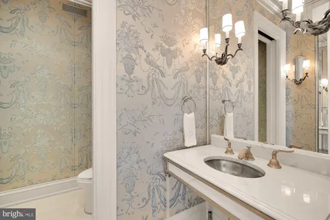 a bathroom with a tub sink and large windows