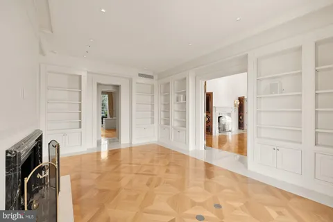 a balcony with chairs and glass door