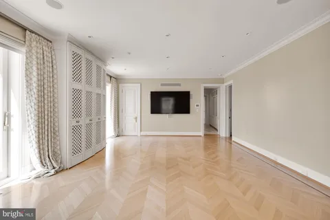 a view of empty room with wooden floor and fireplace