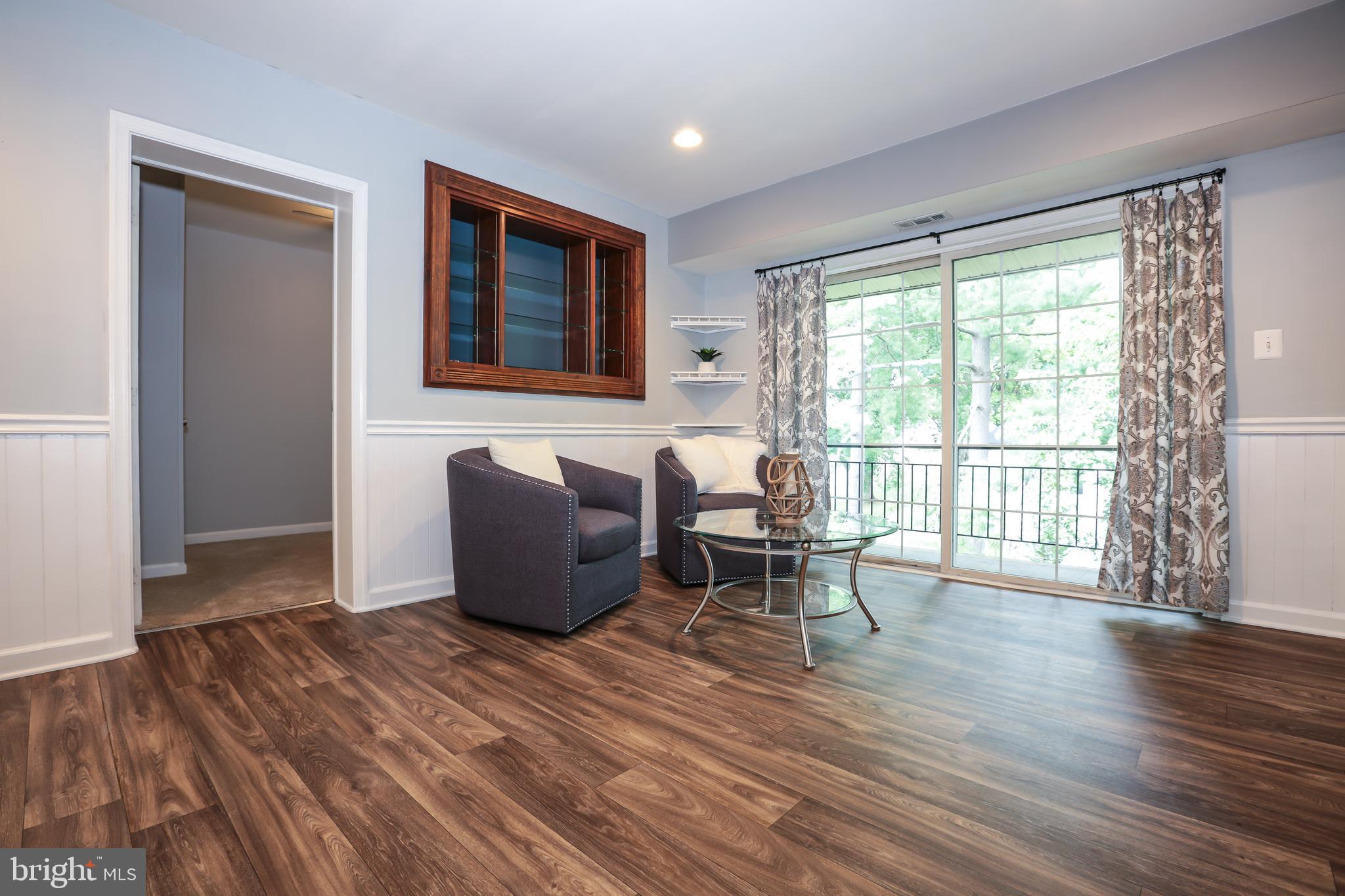 635 Waterloo Road, Unit 233 Warrenton, VA 20186 - Photo 4 of 19 Living Room w/ Natural Lighting and Tree Views