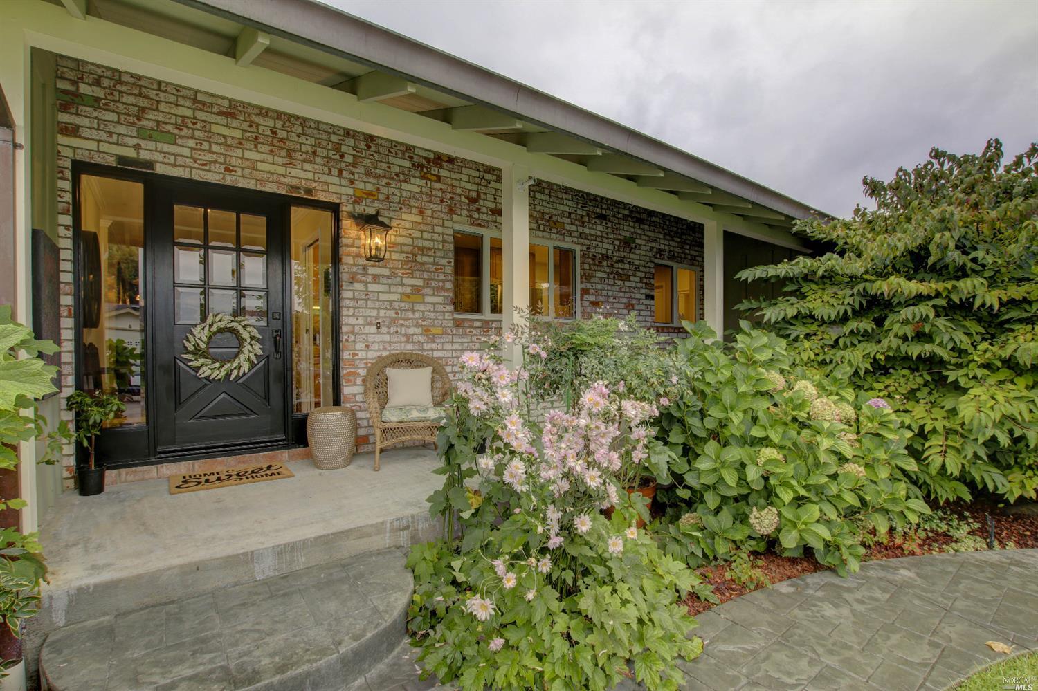 a front view of a house with a garden