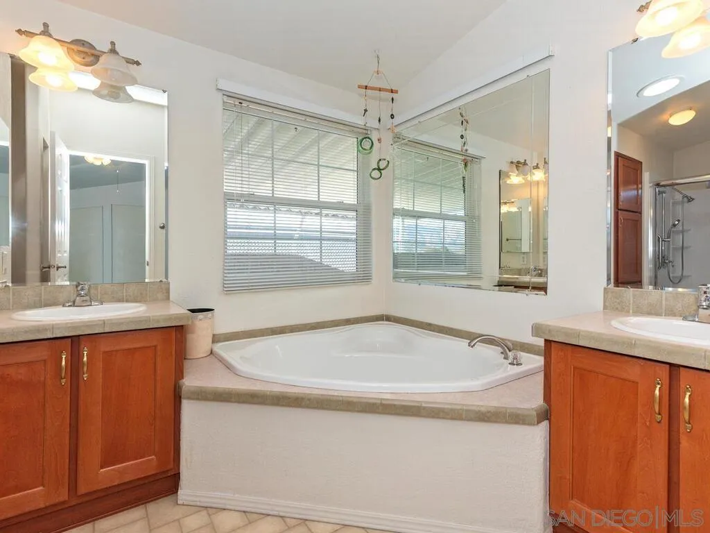 9500 Harritt Road, Unit 31 Lakeside, CA 92040 - Photo 20 of 33 a bathroom with a tub sink and mirror