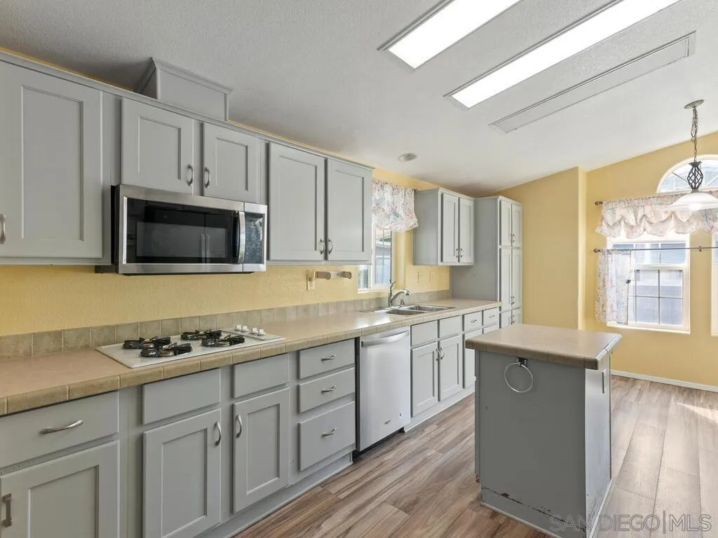 9500 Harritt Road, Unit 31 Lakeside, CA 92040 - Photo 7 of 33 a kitchen with granite countertop cabinets and steel stainless steel appliances