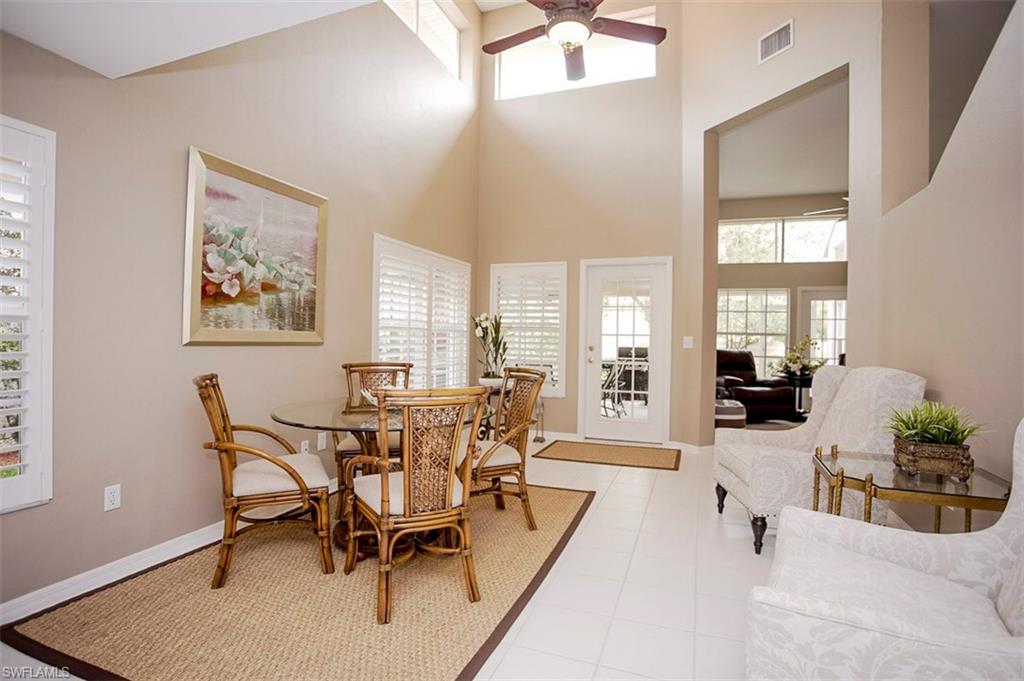 168 Napa Ridge Way Naples, FL 34119 - Photo 13 of 22 a view of a dining room with furniture and wooden floor