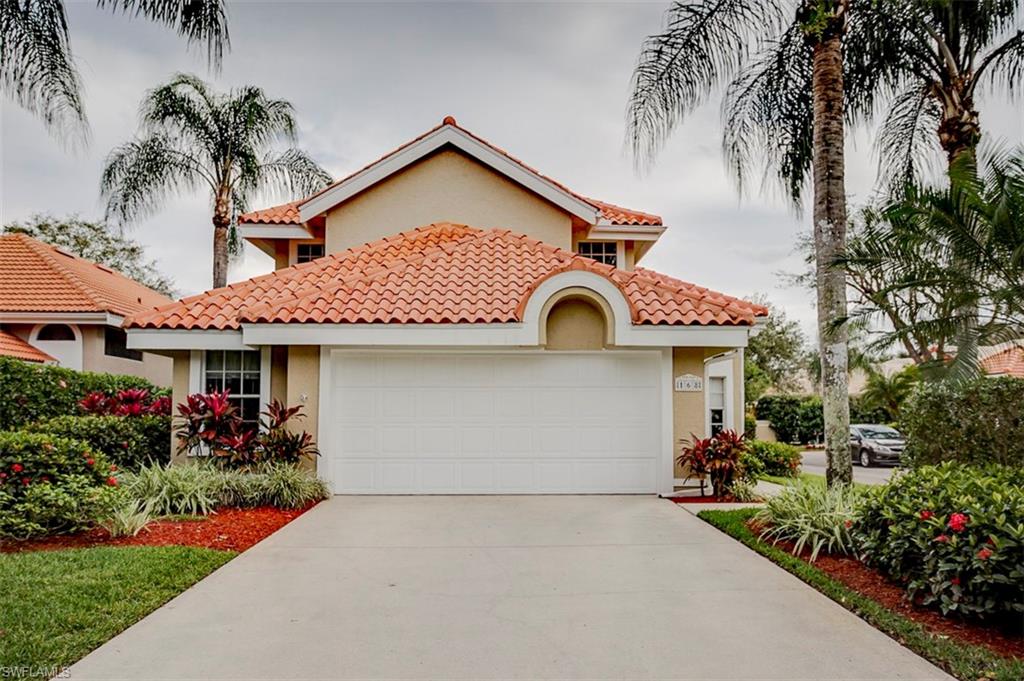168 Napa Ridge Way Naples, FL 34119 - Photo 2 of 22 a front view of a house with a garden