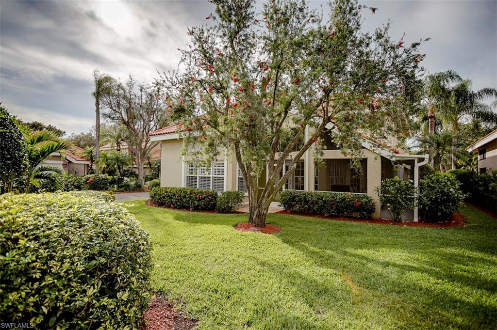 168 Napa Ridge Way Naples, FL 34119 - Photo 21 of 22 a front view of house with yard and green space