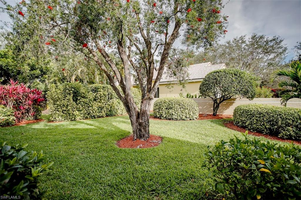 168 Napa Ridge Way Naples, FL 34119 - Photo 22 of 22 a view of a garden with a tree