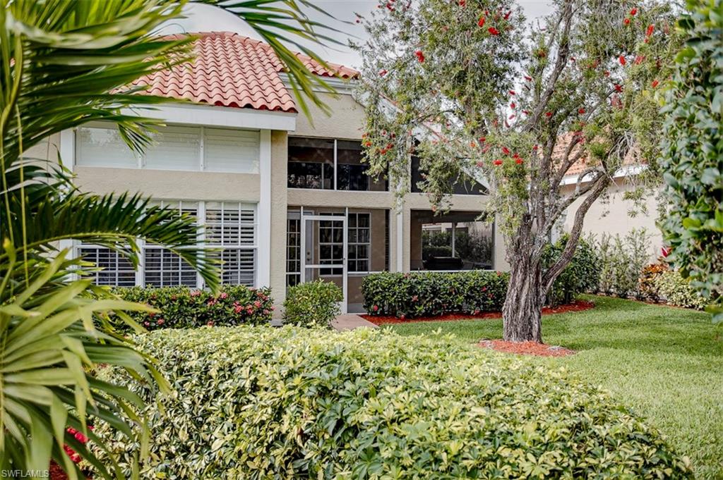 168 Napa Ridge Way Naples, FL 34119 - Photo 3 of 22 front view of a house with a yard
