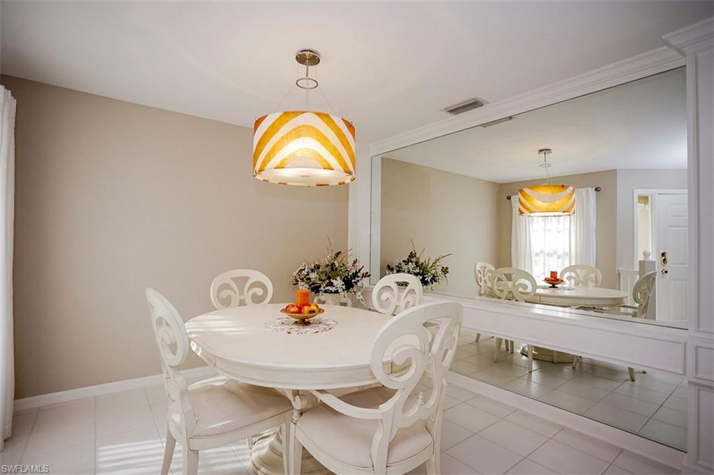 168 Napa Ridge Way Naples, FL 34119 - Photo 4 of 22 a view of a dining room and a kitchen