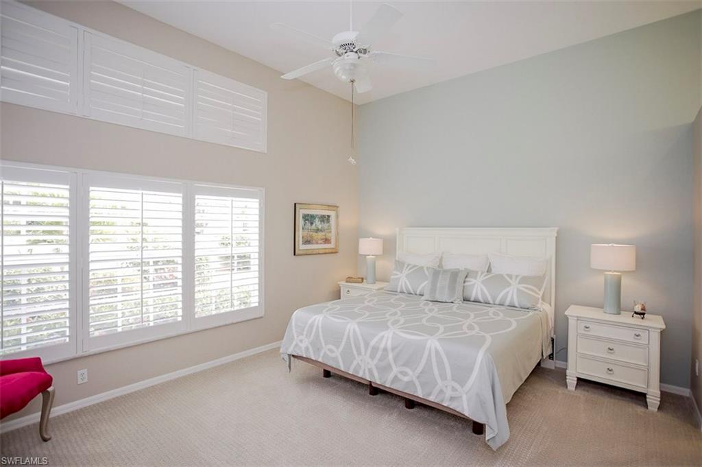 168 Napa Ridge Way Naples, FL 34119 - Photo 9 of 22 a bedroom with a bed and a couch