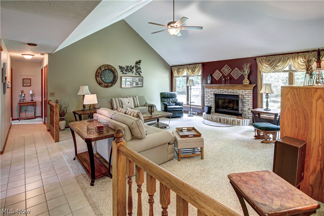 1010 Rustic Trail Cleveland, OH 44134 - Photo 13 of 49 Great room with a healthy amount of sunlight, tile flooring, ceiling fan, and a fireplace