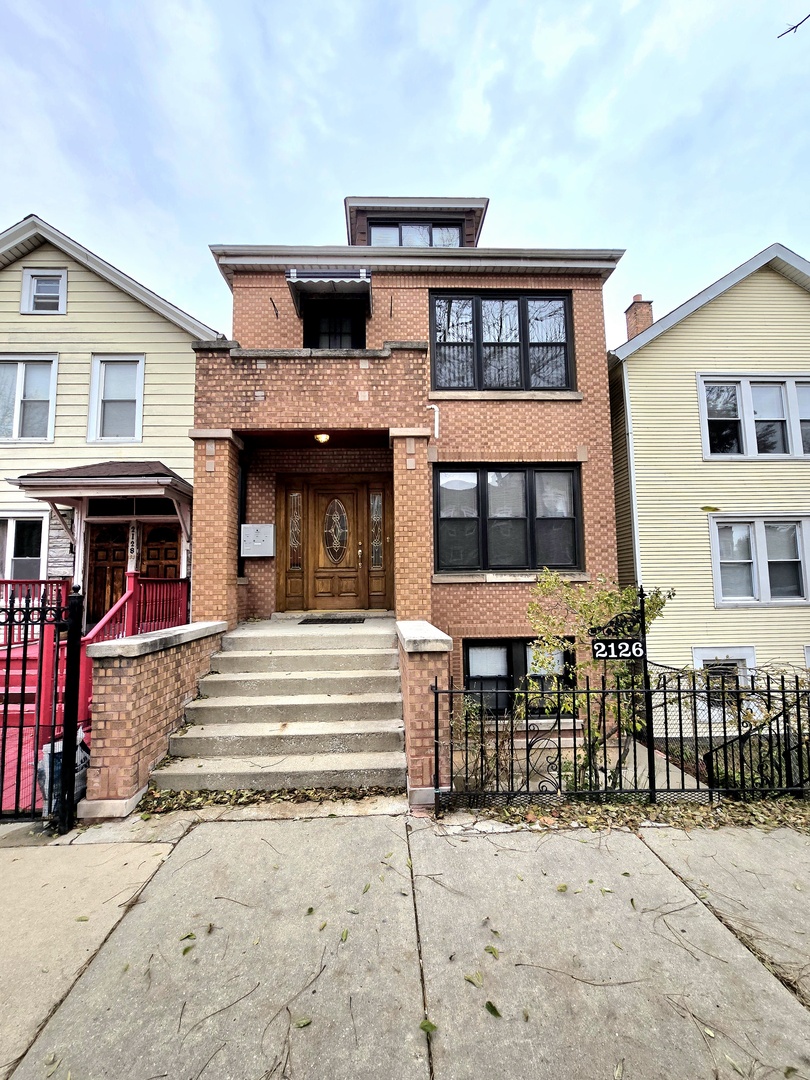 2126 West 24th Street, Unit 2 Chicago, IL 60608 - Photo 1 of 16 a front view of a house with a porch