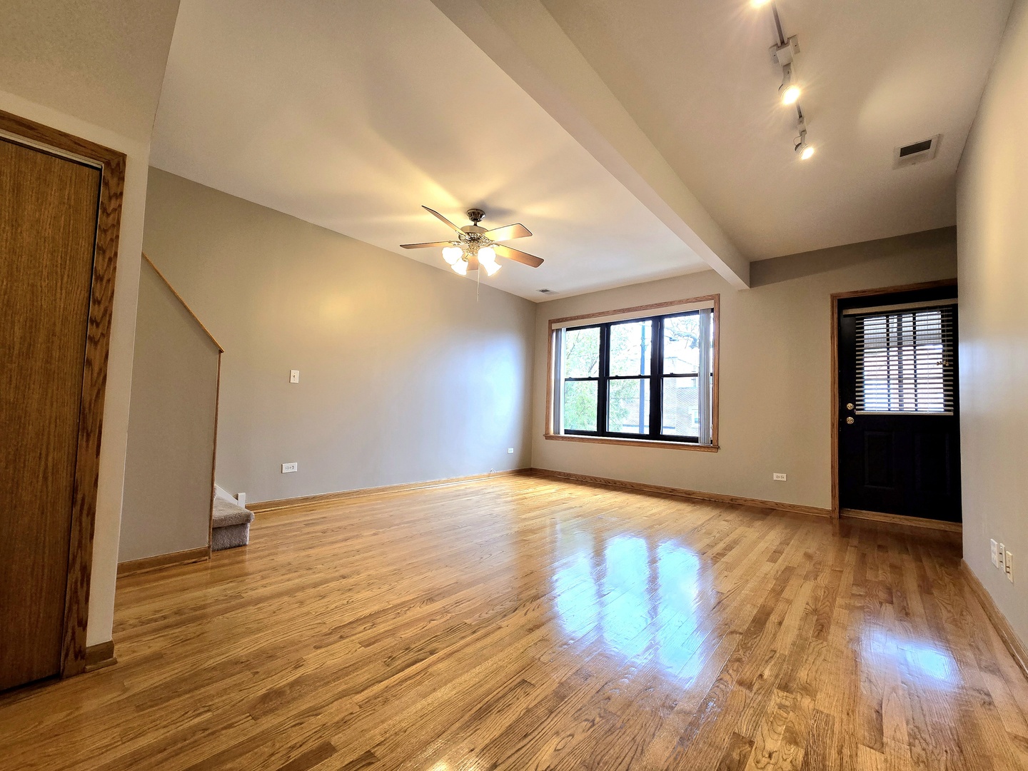 2126 West 24th Street, Unit 2 Chicago, IL 60608 - Photo 2 of 16 a view of an empty room with window and wooden floor