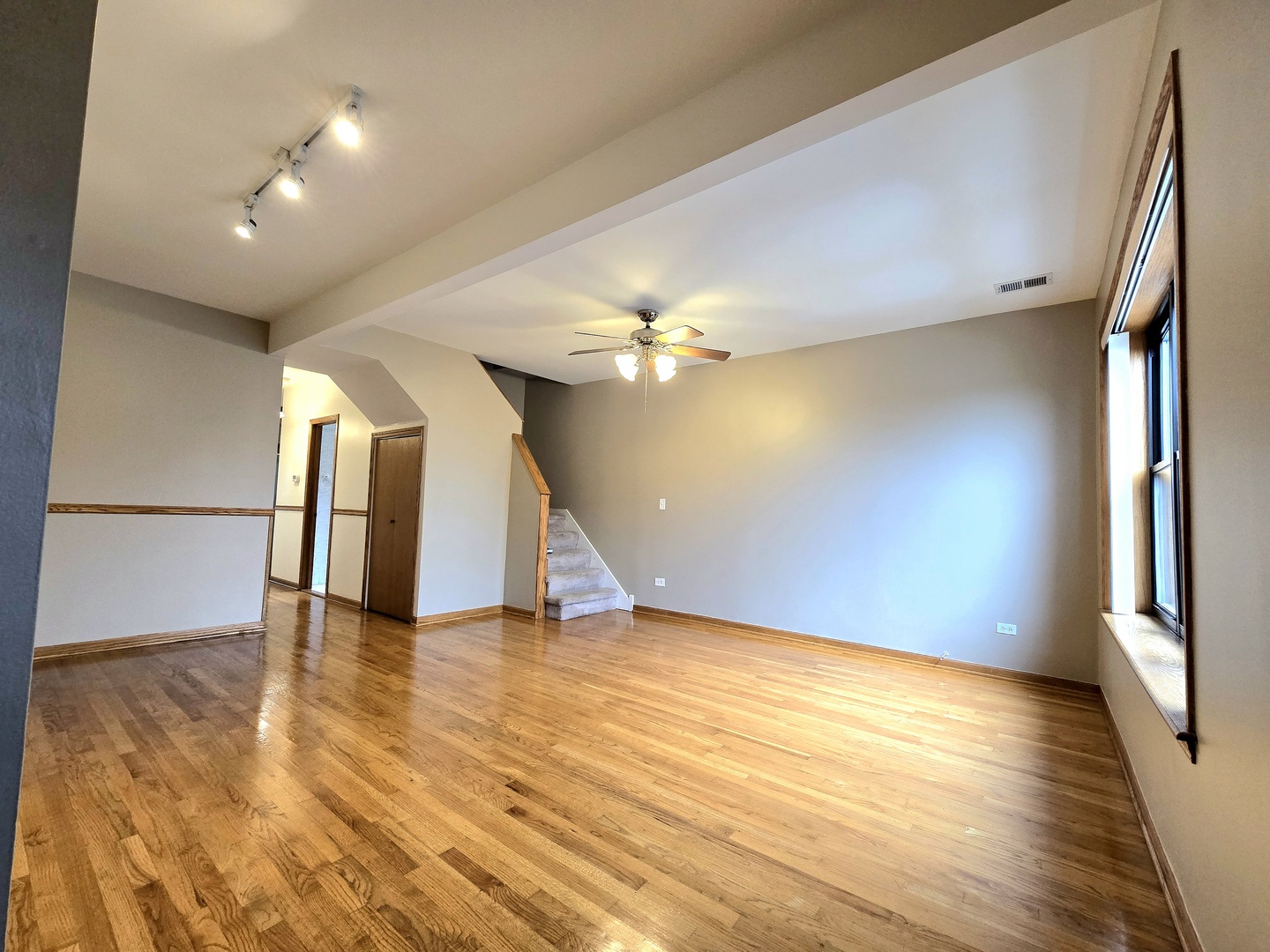 2126 West 24th Street, Unit 2 Chicago, IL 60608 - Photo 3 of 16 a view of an empty room with wooden floor and a window