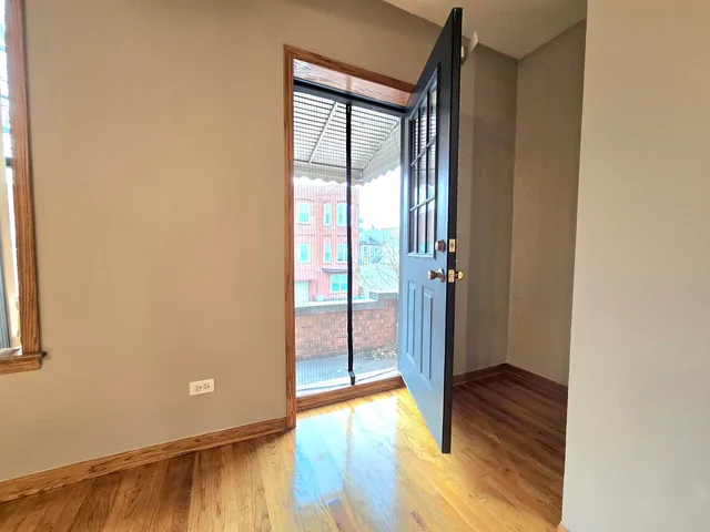 a view of front door with wooden floor