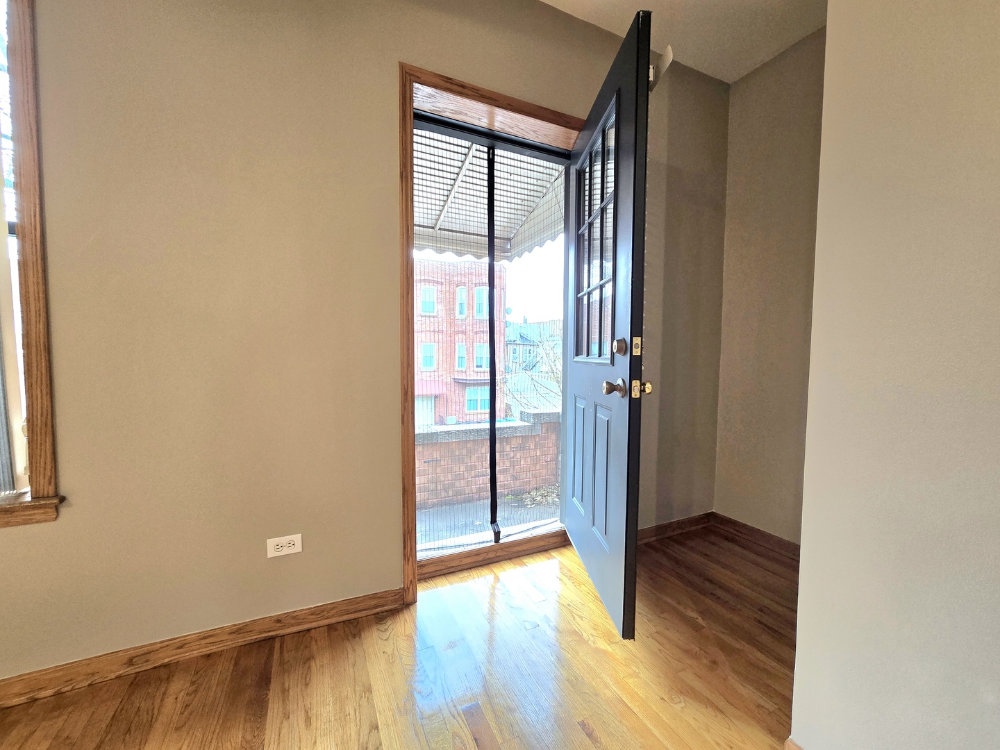 2126 West 24th Street, Unit 2 Chicago, IL 60608 - Photo 5 of 16 a view of front door with wooden floor